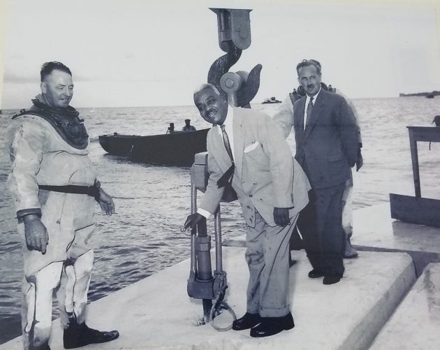 1961 Premiere of Barbados Dr. Hugh Cummins (Centre) lowering the last block on the breakwater